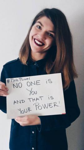 Girl holding a sign that says: No one is you and that is your power!